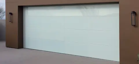 Double frameless full-view garage door in white glass, 4 panels high and 2 wide, between wall lanterns on a brown stucco wall