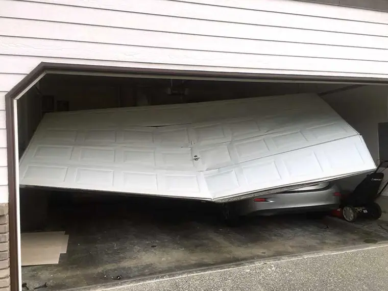 Before: a white steel sectional folded in the opening and off its track