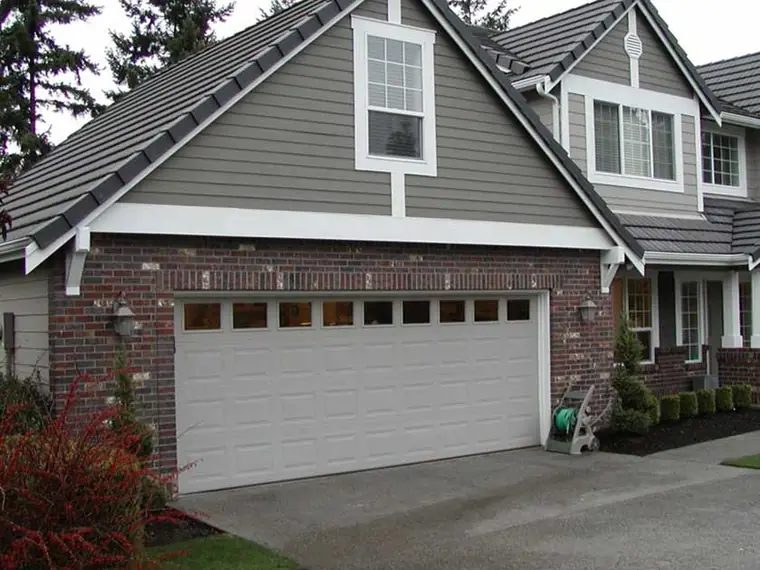 Before: a single raised-panel door on a brick-and-siding house under a steep gable