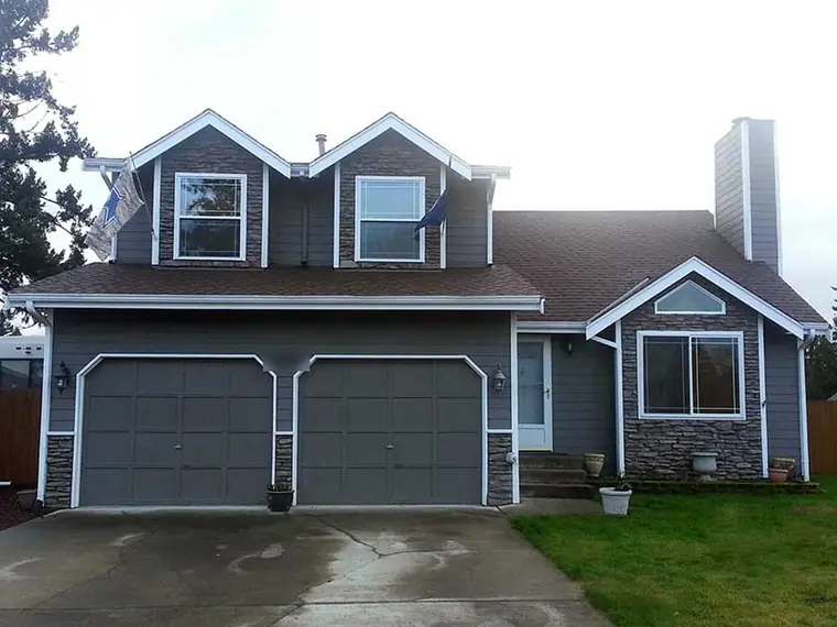 Before: two flat gray sectionals under gables that have their own window shapes
